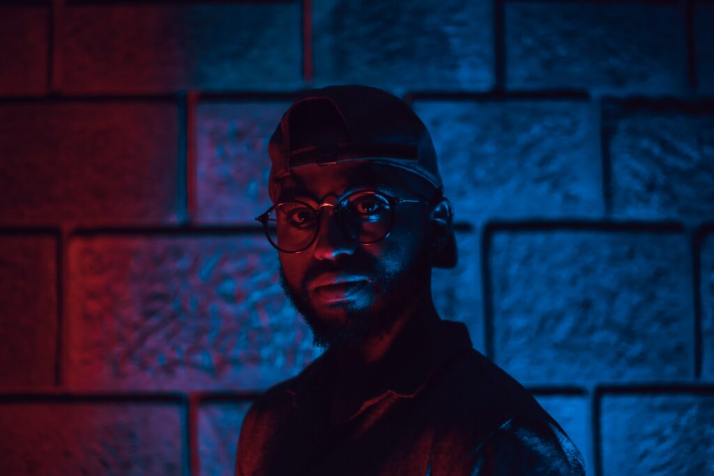 photo of man wearing glasses in dim light