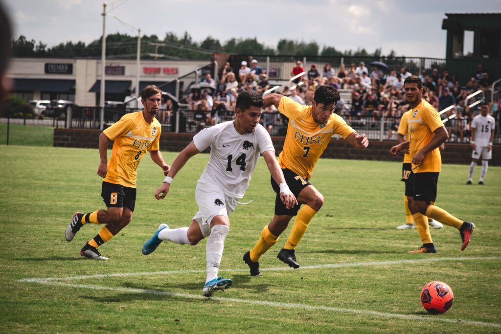 photo of a couple of guys playing football