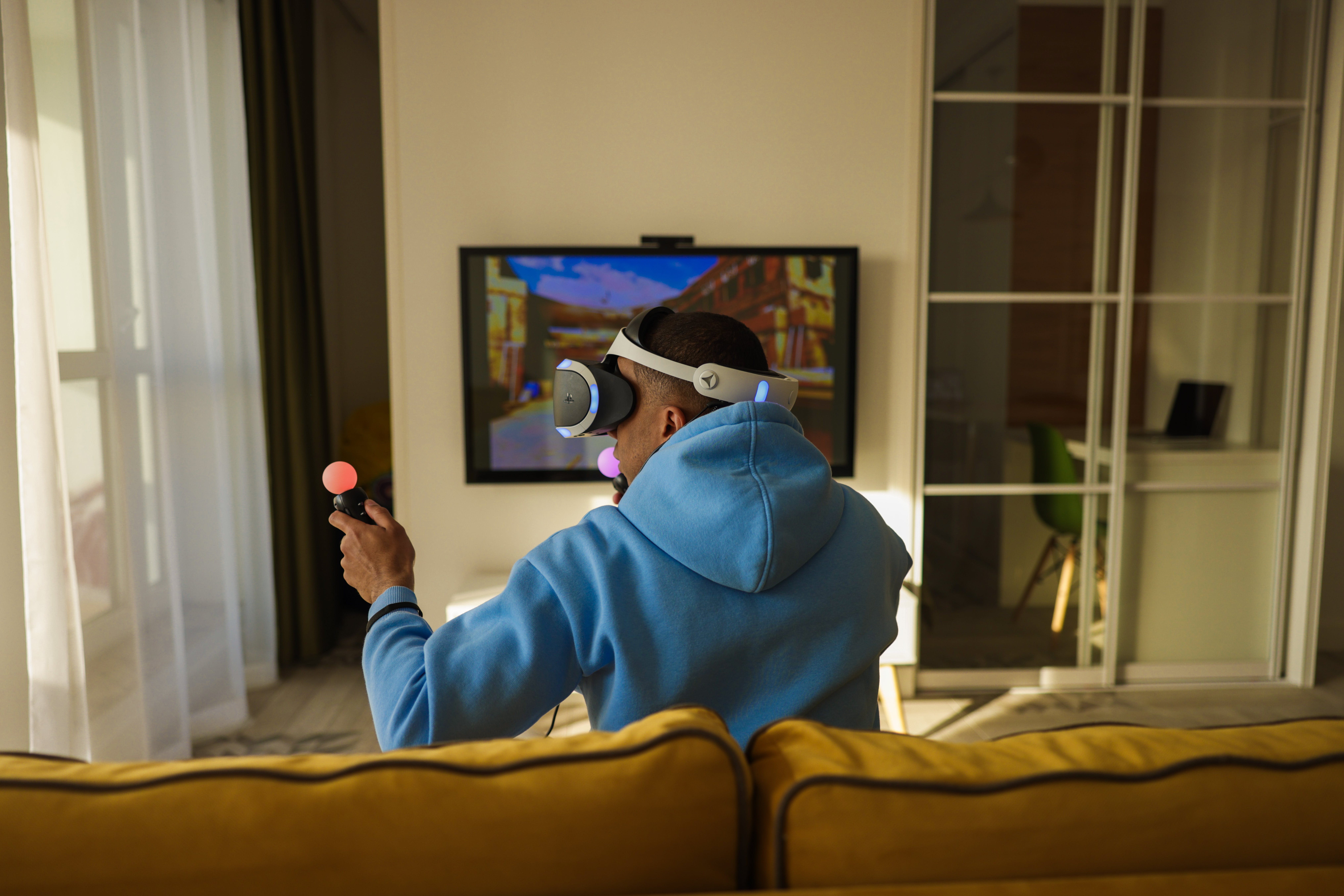 photo of man playing with VR headset